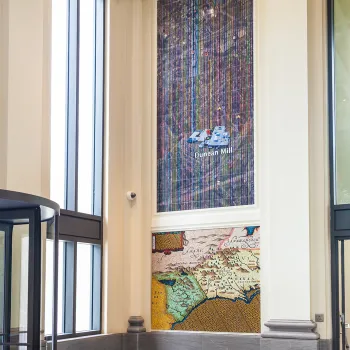 A suite of ceramic tile and glass mosaics that feature present-day Google Earth aerial views of textile mills in communities served by the courthouse.